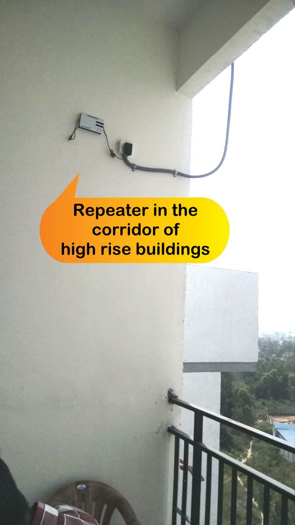 Balcony Repeater Setup - Outdoor-rated repeater mounted on balcony for extended range to adjacent buildings.