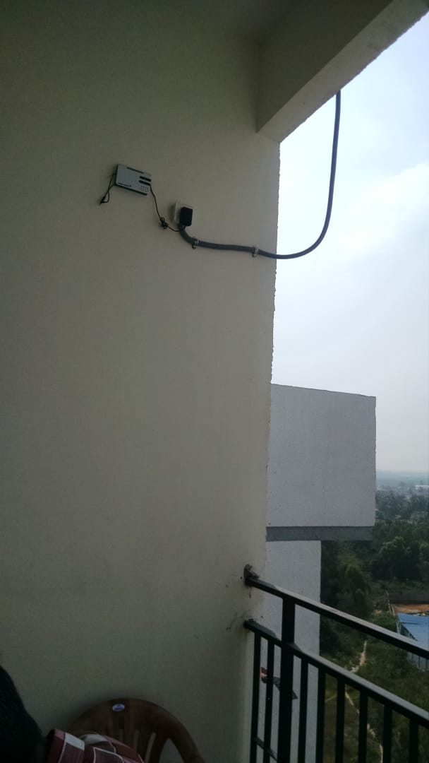 Outdoor Repeater Installation - Weather-resistant signal repeater installed in outdoor location for campus-wide coverage.