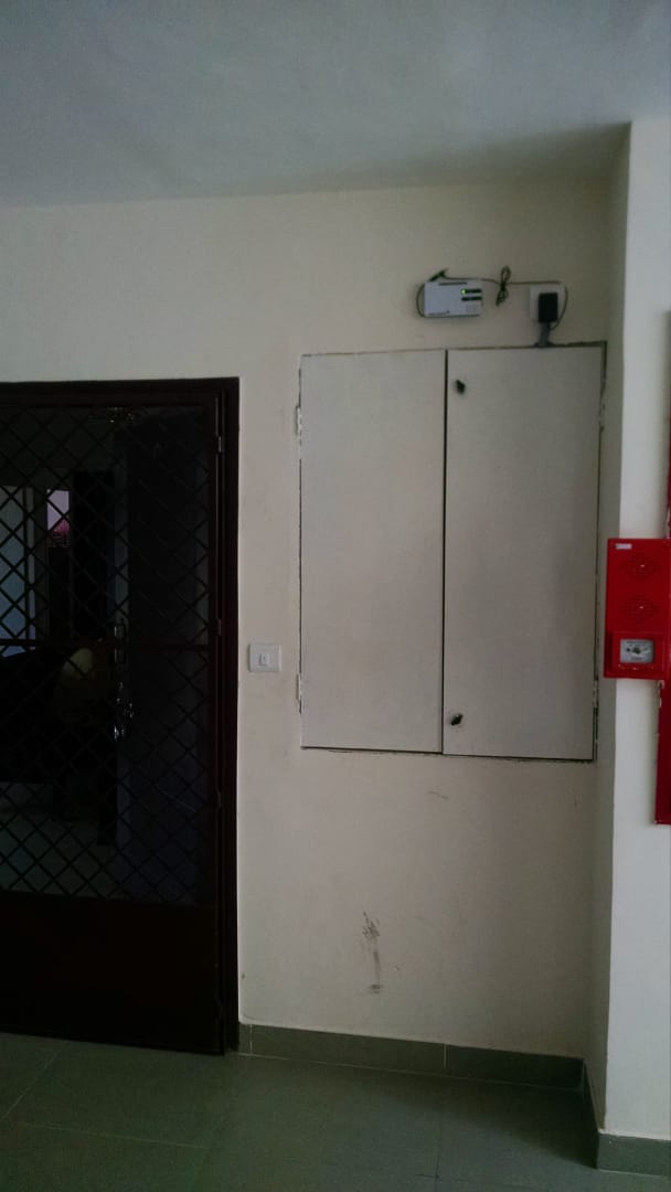 Residential Signal Booster - Compact signal booster installed in apartment complex for wireless alarm coverage.