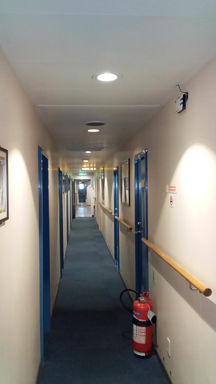 Range Enhancement Booster - Signal booster installation for extending communication range in multi-story buildings.